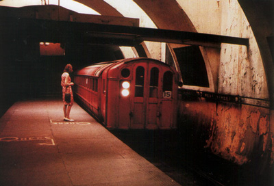 A woman standing on the platform of West St. station on the old Glasgow Underground