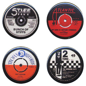 Four badges of the centre labels from Atlantic Records, 2 Tone, Trojan and Stiff