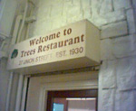 The sign over the door of the Trees Restaurant